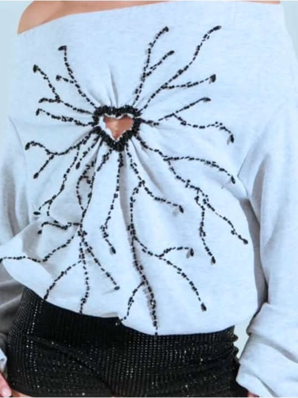 AKIRA Off-Shoulder Light Blue Sweatshirt with Black Beaded Heart Burst